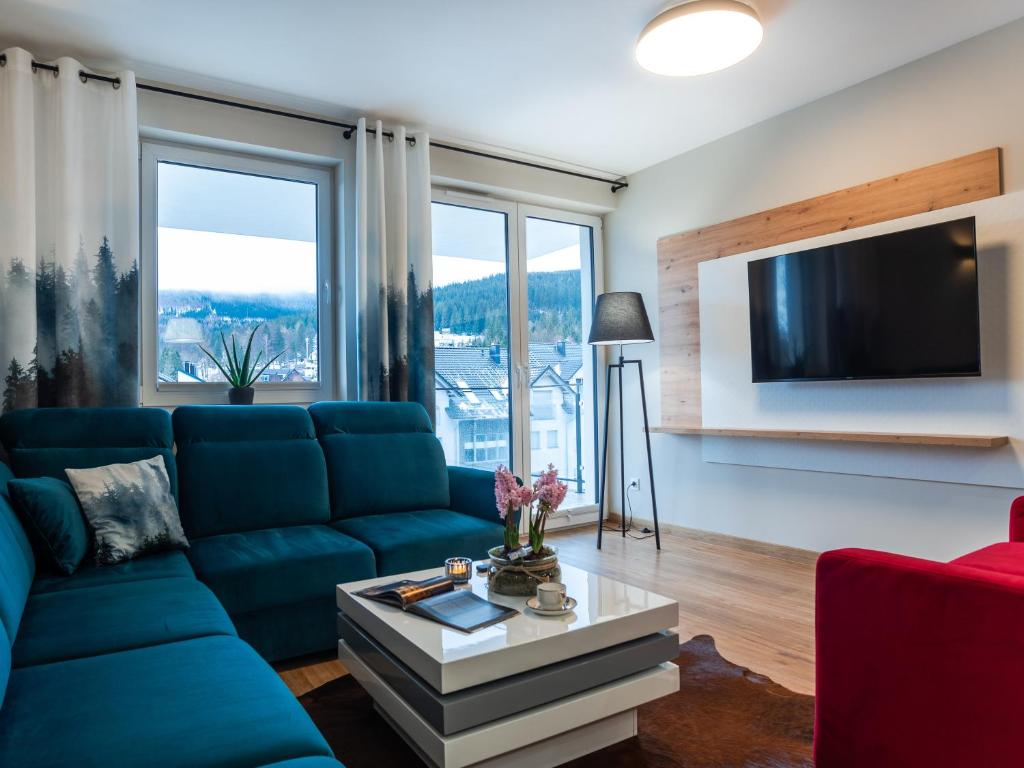 Televízia a/alebo spoločenská miestnosť v ubytovaní Apartamenty na Polnej