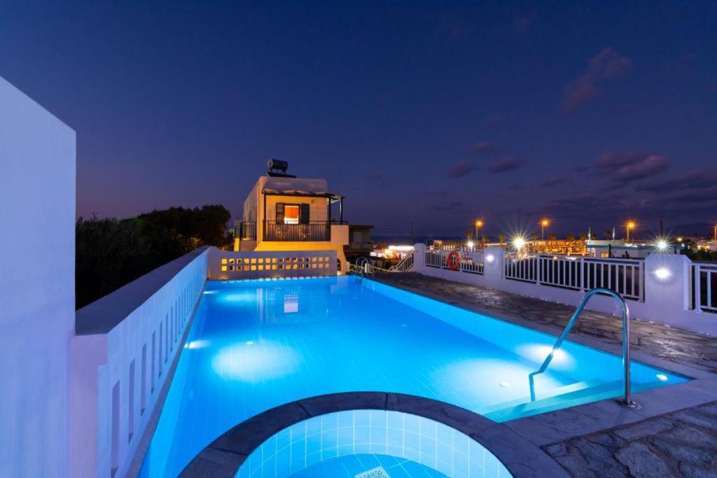 a swimming pool at night with a building at Okirroi Villas Chersonissos in Hersonissos
