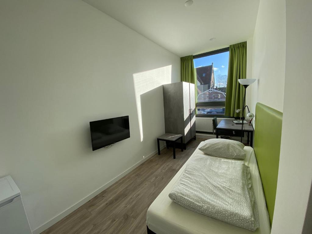 Ένα ή περισσότερα κρεβάτια σε δωμάτιο στο Short Stay Wageningen