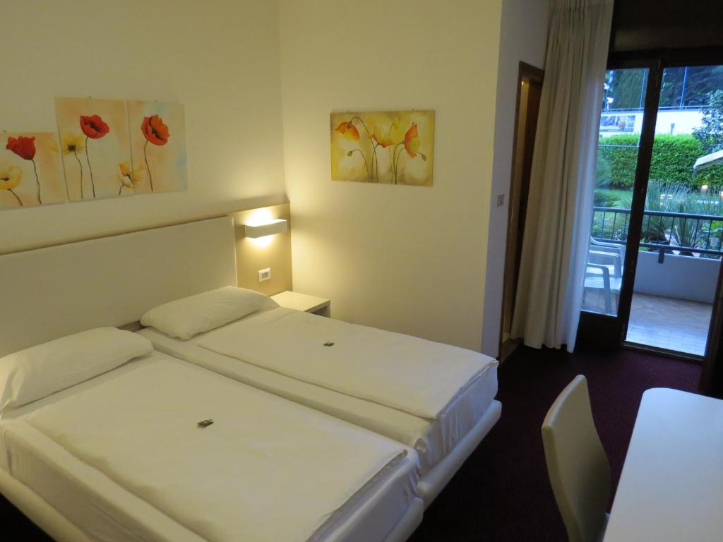 Postel nebo postele na pokoji v ubytování Hotel Villa Claudia