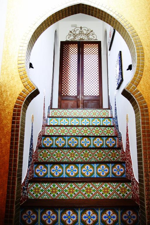 a staircase in a building with colorful tiles at Raid Garden Boutique Hotel in Magong