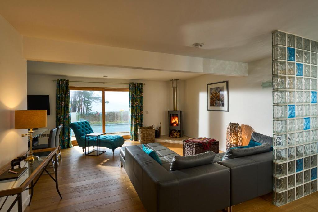 a living room with a couch and a table at Tanamuir, overlooking Loch Fyne, Strachur in Cairndow
