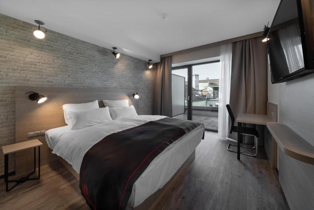 Posteľ alebo postele v izbe v ubytovaní DORMERO Hotel Budapest