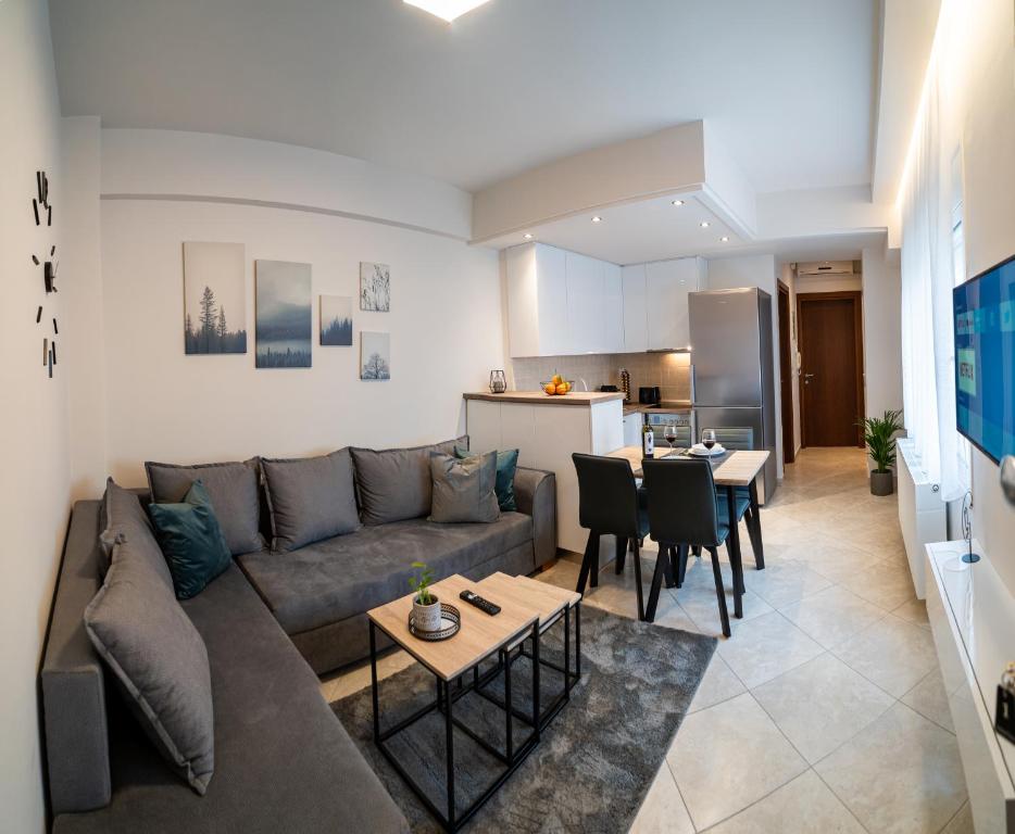 a living room with a couch and a kitchen at Diamond Palace Trikala in Tríkala