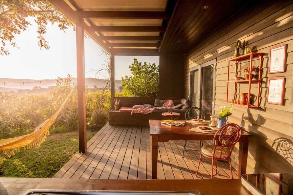 a screened in porch with a table and a couch at Gato Preto de Silves - Adults Only in Silves