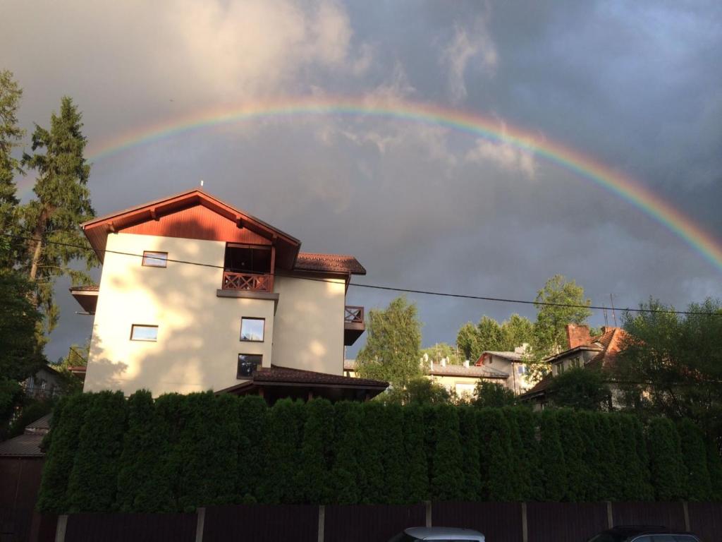 a rainbow in the sky above a house at Apartament Joanna in Rabka-Zdrój