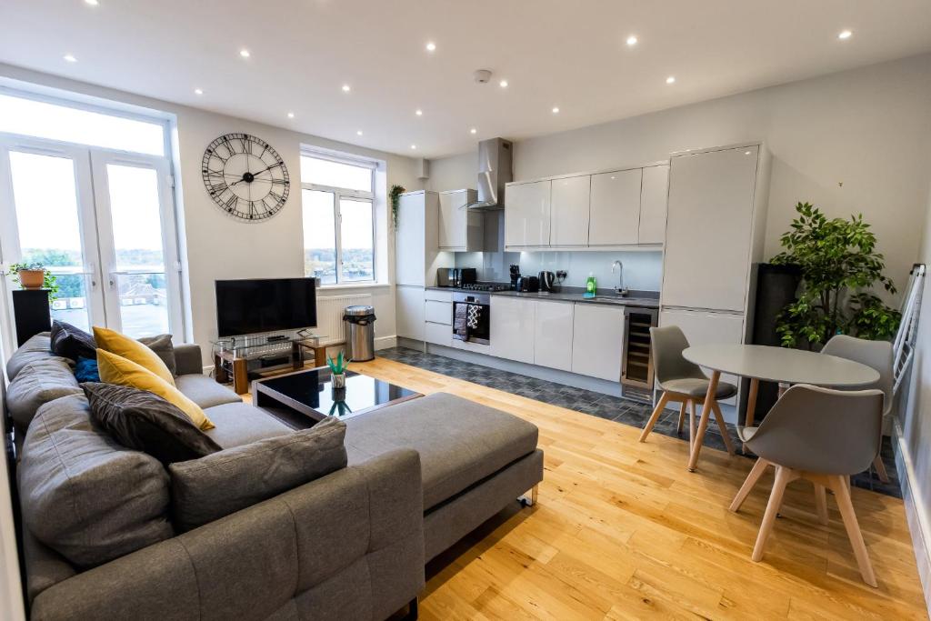 a living room with a couch and a table at Thorpe Road 1 Bed Apartment with Parking in Norwich