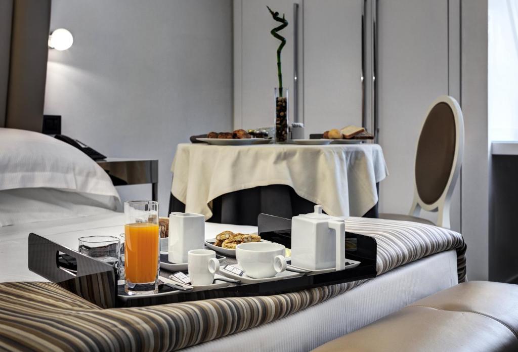 a hotel room with a tray of food on a table at LHP Napoli Palace & SPA in Naples