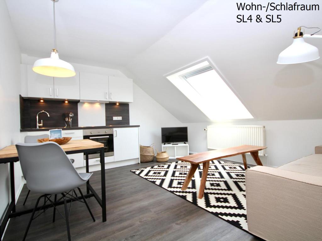 a kitchen and dining room with a table and chairs at Haus Strandleben in Norderney