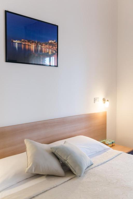 Postel nebo postele na pokoji v ubytování Hotel Viola