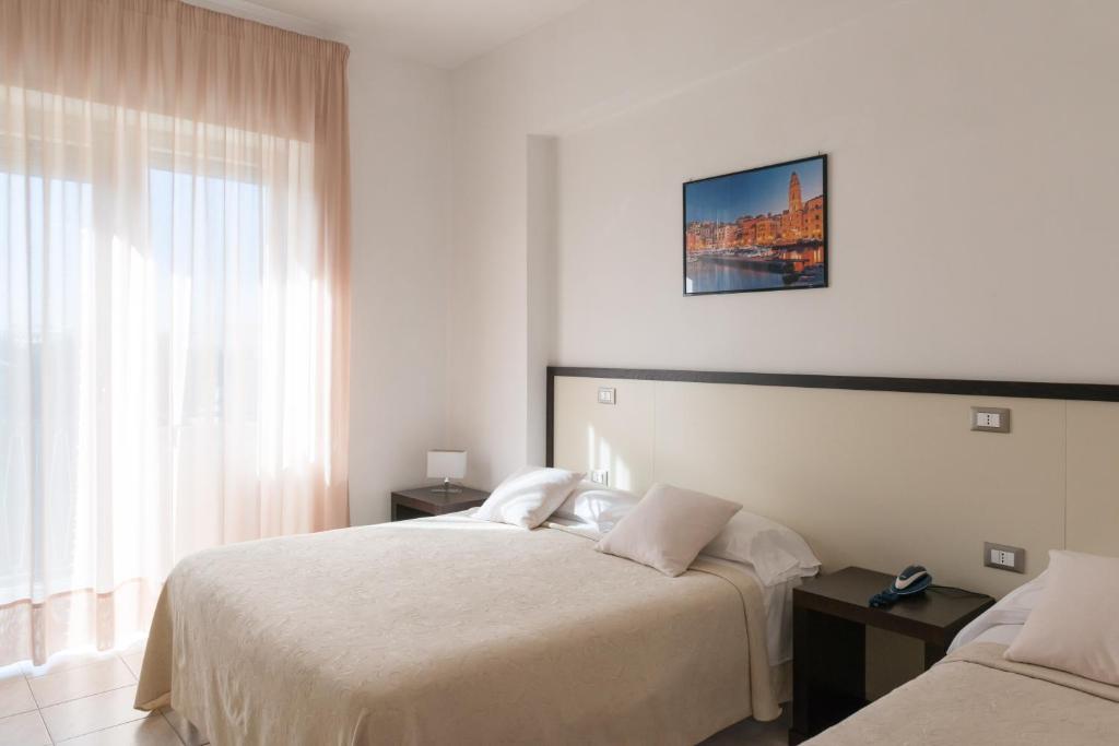 Postel nebo postele na pokoji v ubytování Hotel Viola