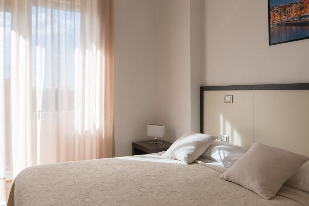 Postel nebo postele na pokoji v ubytování Hotel Viola