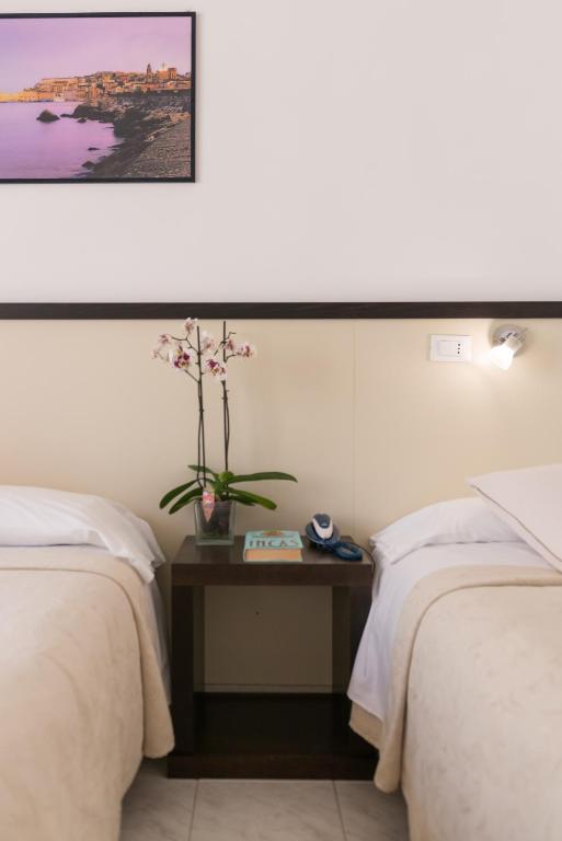 Postel nebo postele na pokoji v ubytování Hotel Viola