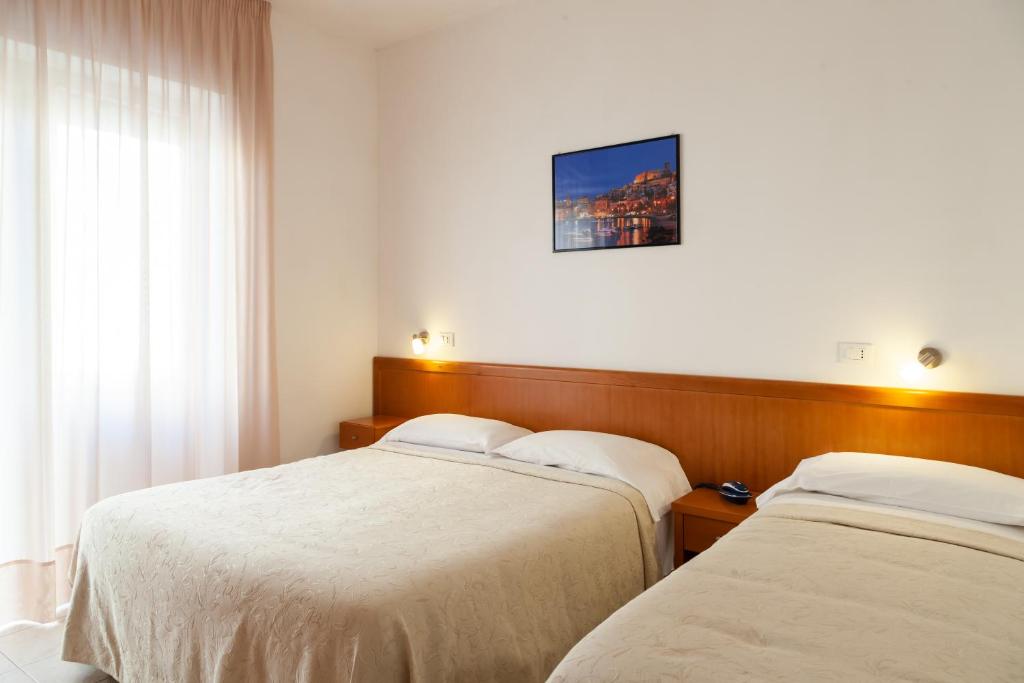 Postel nebo postele na pokoji v ubytování Hotel Viola