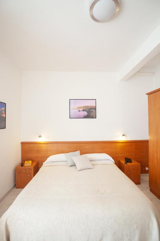 Postel nebo postele na pokoji v ubytování Hotel Viola