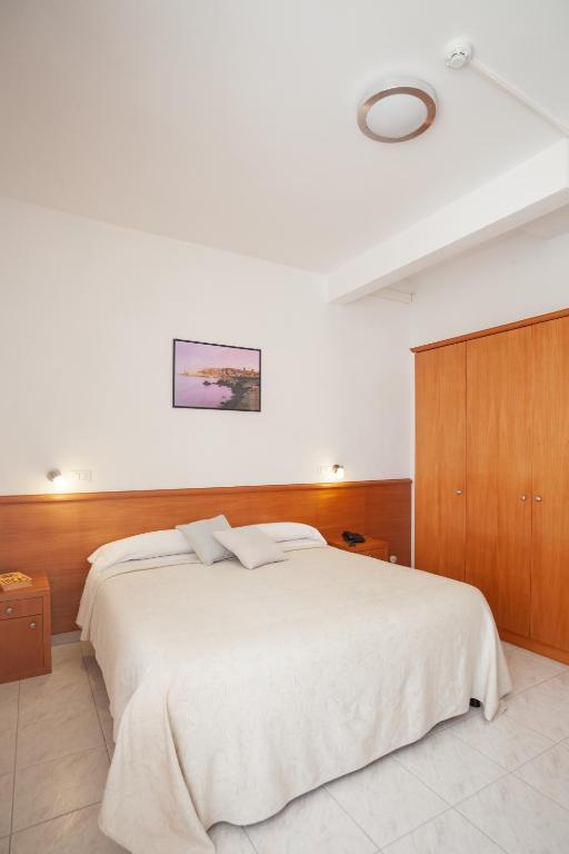 Postel nebo postele na pokoji v ubytování Hotel Viola