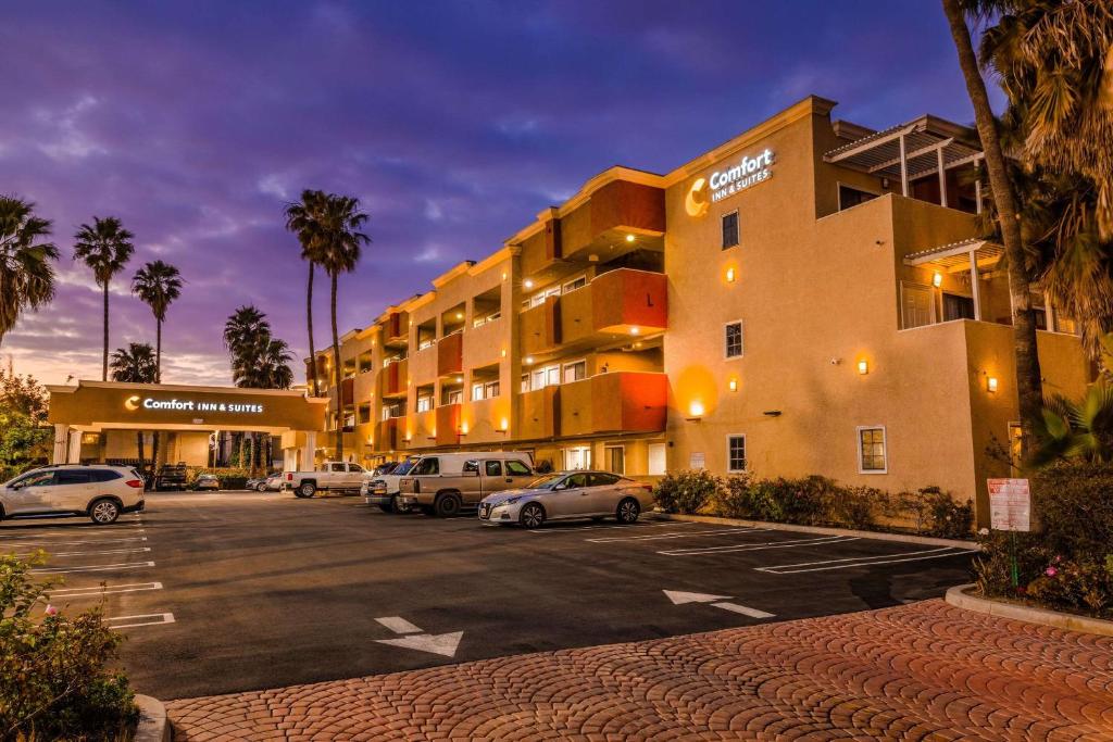 un estacionamiento con coches estacionados frente a un hotel en Comfort Inn & Suites Huntington Beach, en Huntington Beach