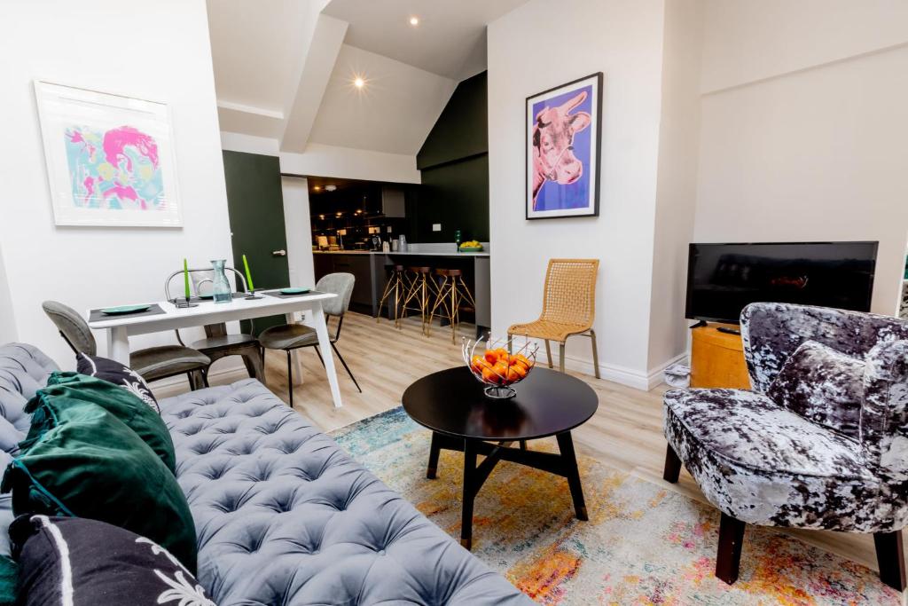 a living room with a couch and a table at Modern 2 Bedroom Queen Street Apartment in Norwich