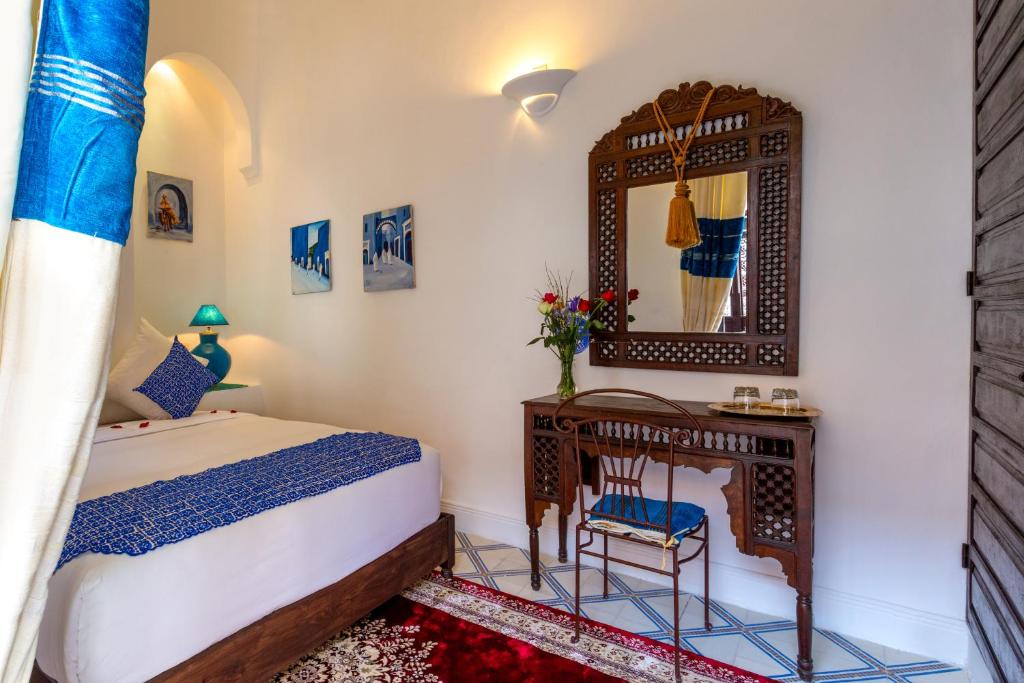 Postel nebo postele na pokoji v ubytování Riad Al Jana