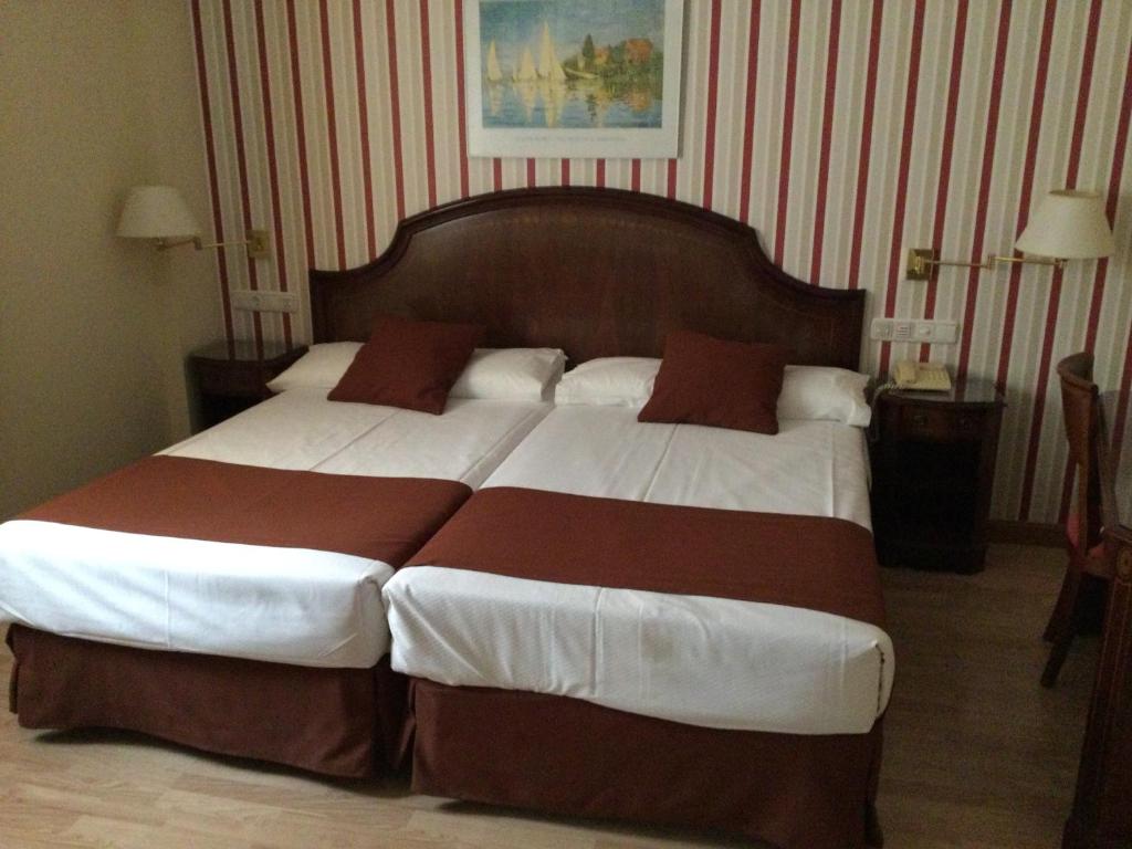 Postel nebo postele na pokoji v ubytování Hotel Cordón