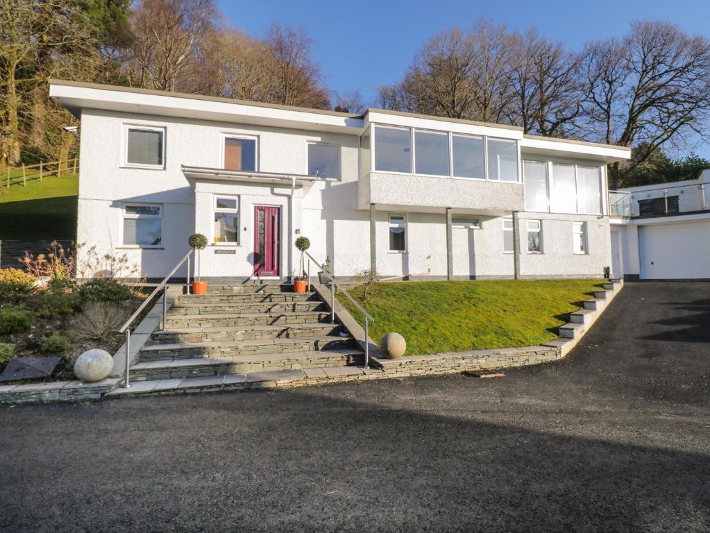 a large white house with a red door at Brantlea in Windermere