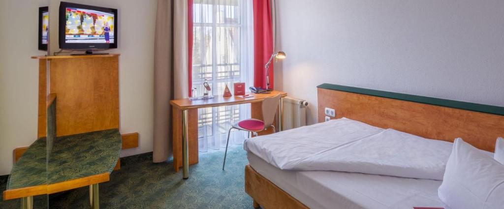 Postel nebo postele na pokoji v ubytování das seidl - Hotel & Tagung - München West