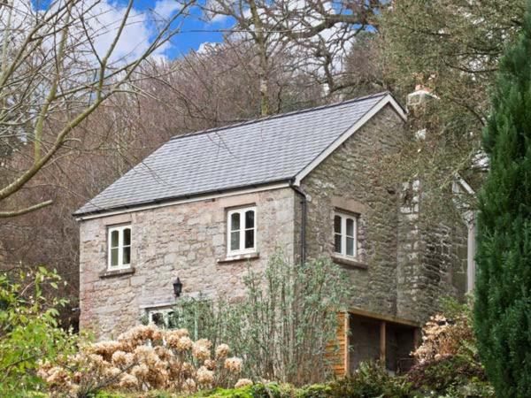 a large stone house with a gray roof at The Generals Cottage in Mitchel Troy