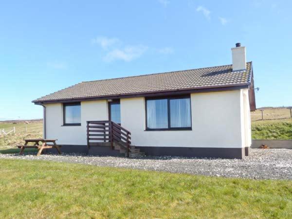 a house with a picnic table in front of it at Ardmore in Trumpan