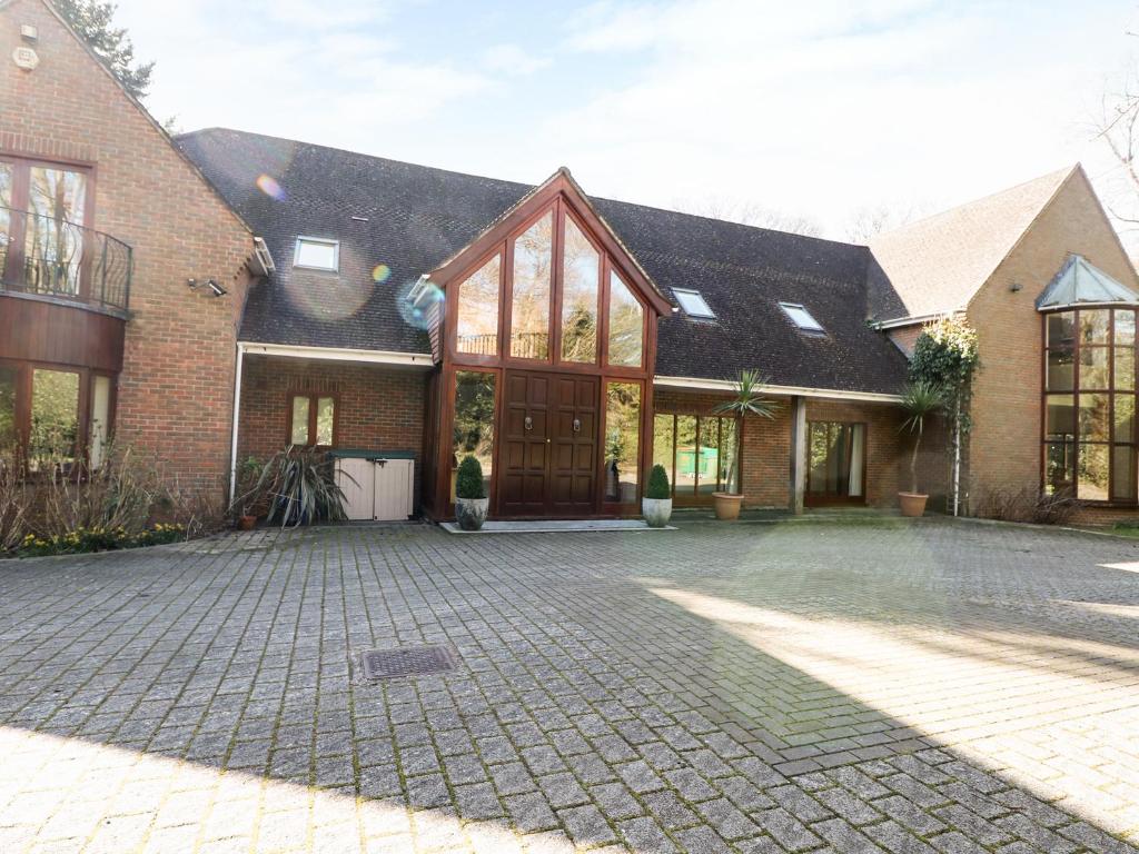 a large brick house with a large glass door at Abbots Wood in Netley