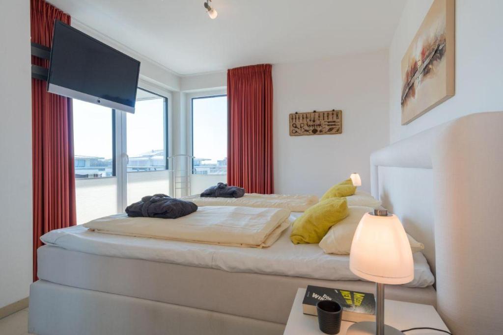 Postel nebo postele na pokoji v ubytování Duenenpark-Heiligenhafen-Haus-Ostseeduene-Wohnung-13-Ostsee-Penthaus