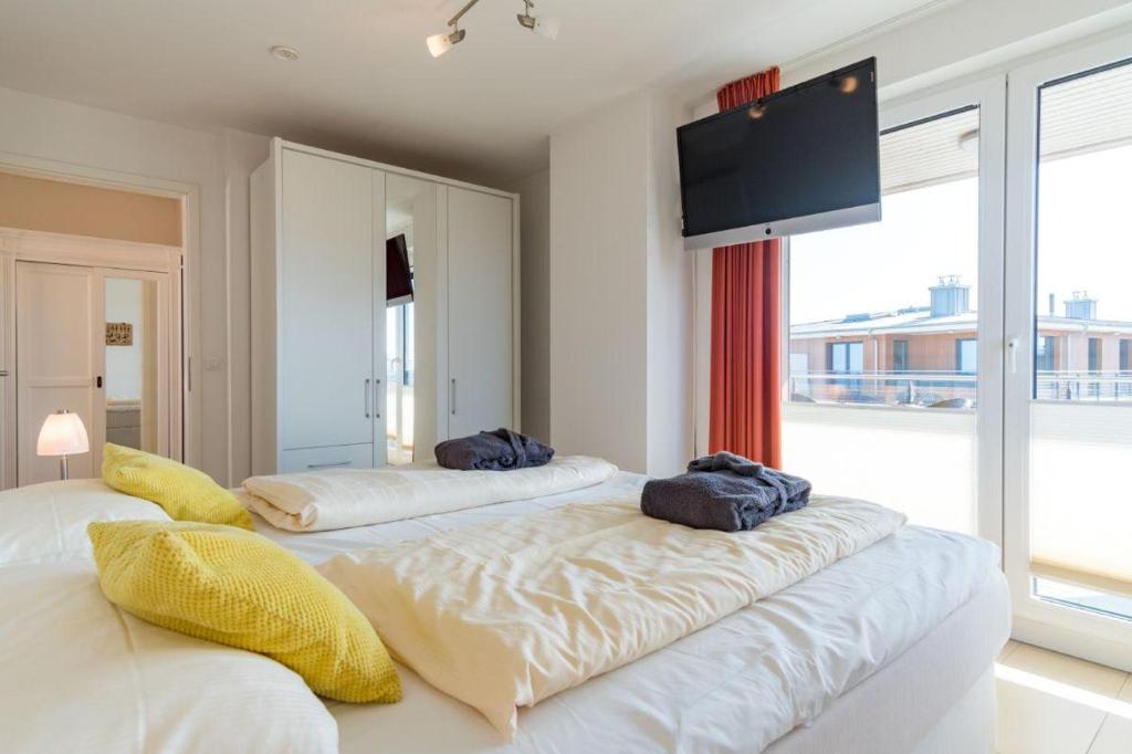 Postel nebo postele na pokoji v ubytování Duenenpark-Heiligenhafen-Haus-Ostseeduene-Wohnung-13-Ostsee-Penthaus