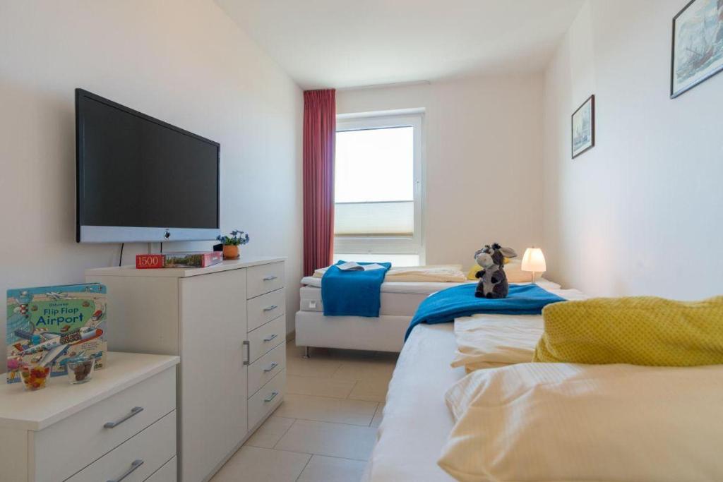 Postel nebo postele na pokoji v ubytování Duenenpark-Heiligenhafen-Haus-Ostseeduene-Wohnung-13-Ostsee-Penthaus