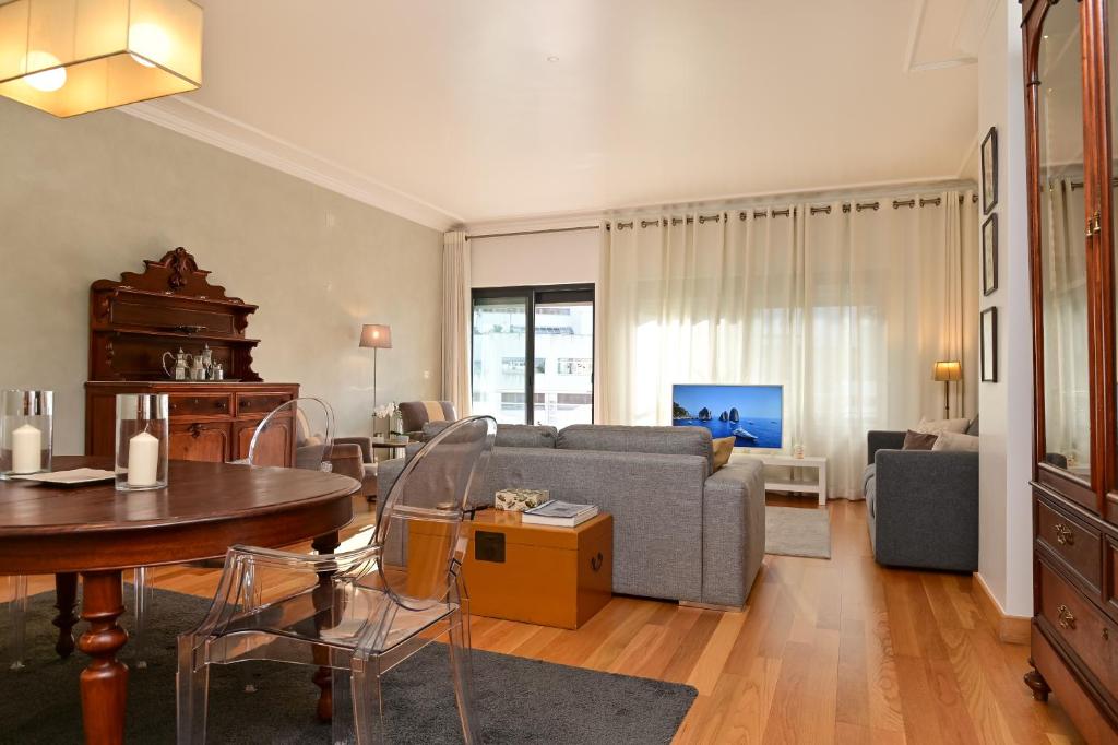 a living room with a couch and a table at Columbano Garden, Family Apartment in Lisbon