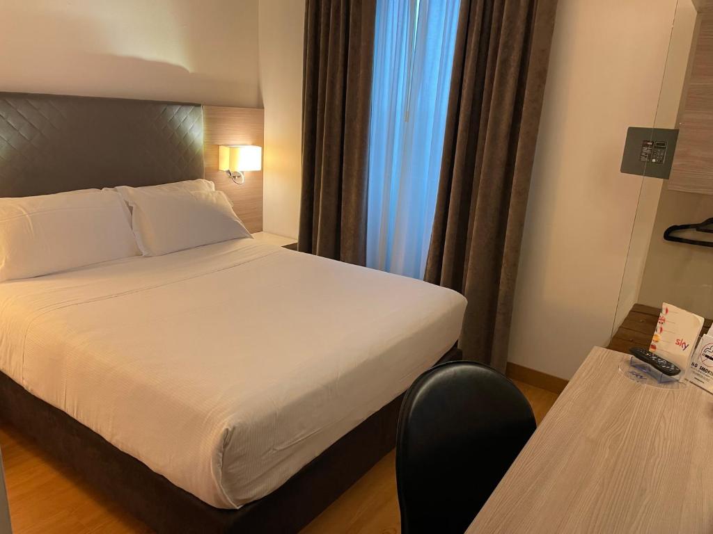 Postel nebo postele na pokoji v ubytování Hotel Omnia
