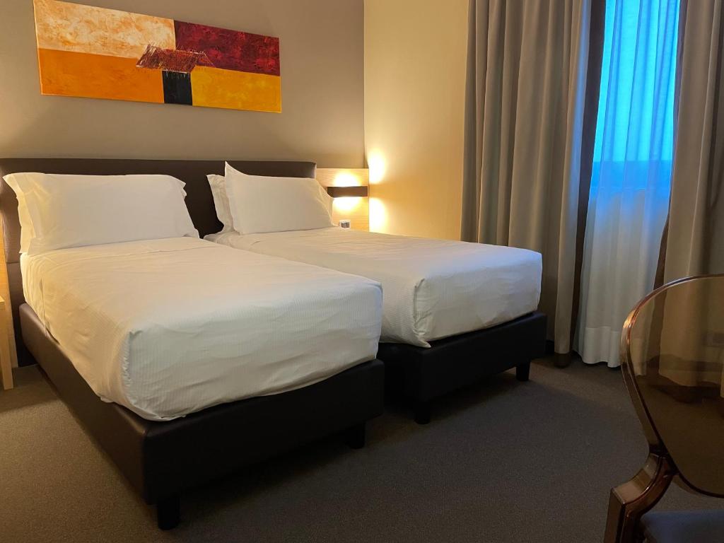 Postel nebo postele na pokoji v ubytování Hotel Omnia