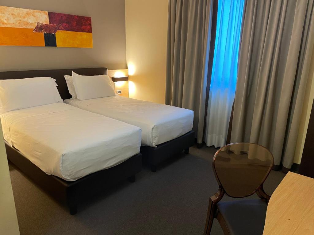 Postel nebo postele na pokoji v ubytování Hotel Omnia
