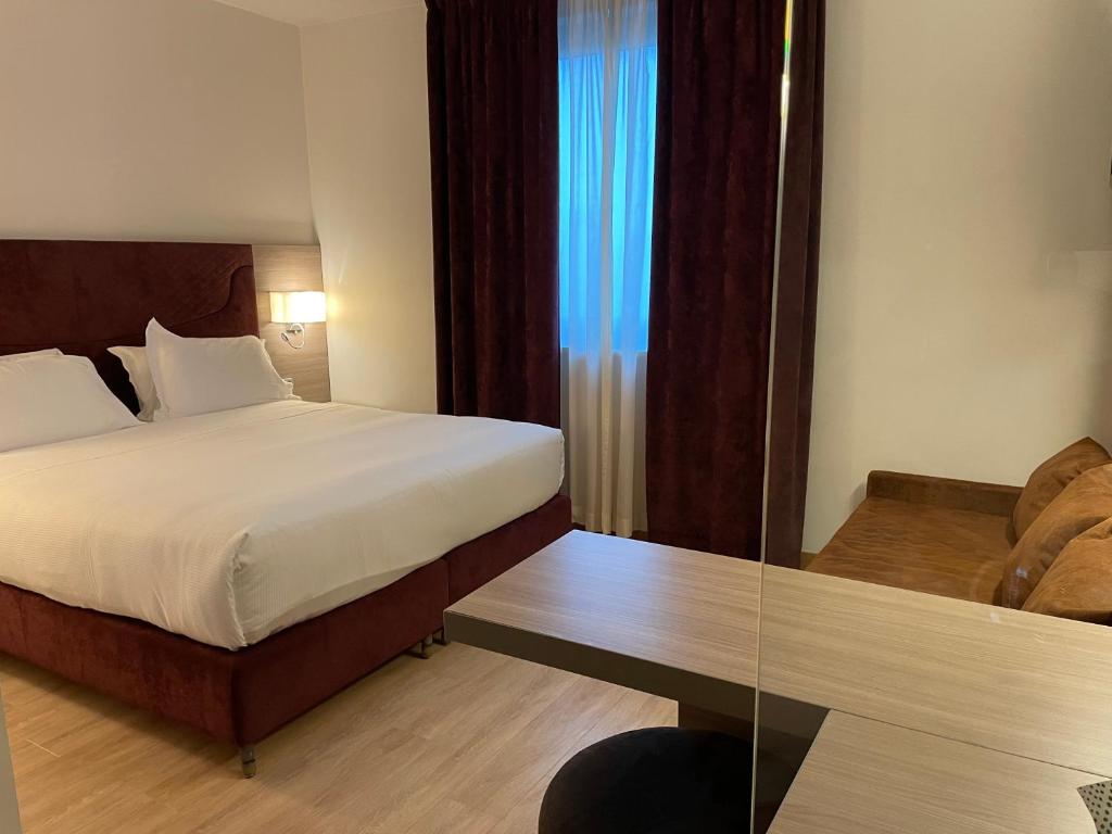 Postel nebo postele na pokoji v ubytování Hotel Omnia