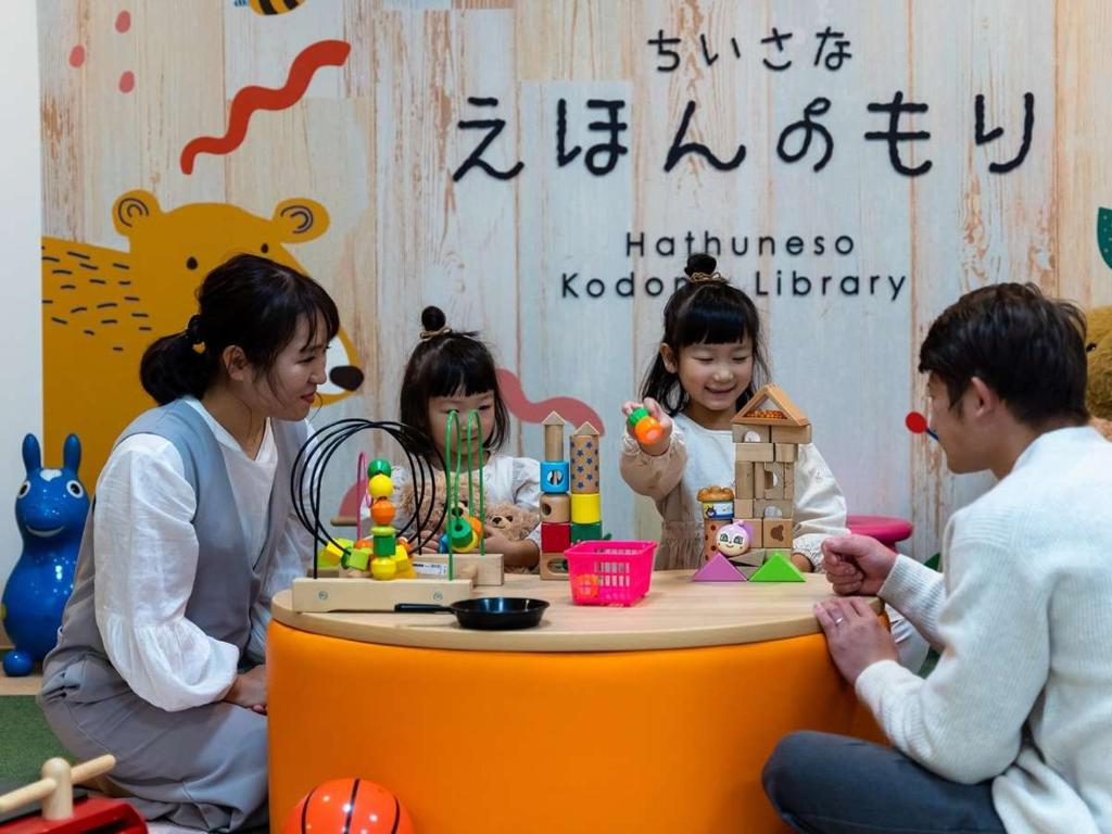 a group of people sitting around a table with toys at Hatsuneso Shinkan in Ureshino