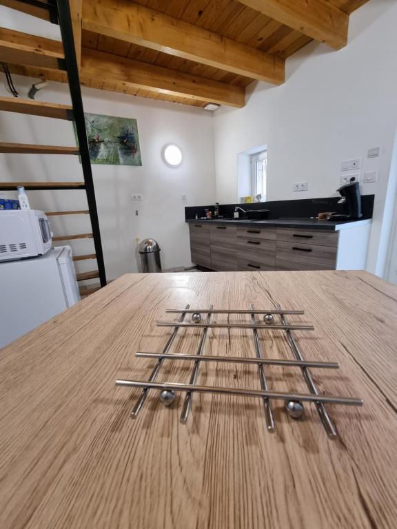 a wooden table with a bunch of sticks on it at Impasse secrète - Duplex - WIFI in Issoire