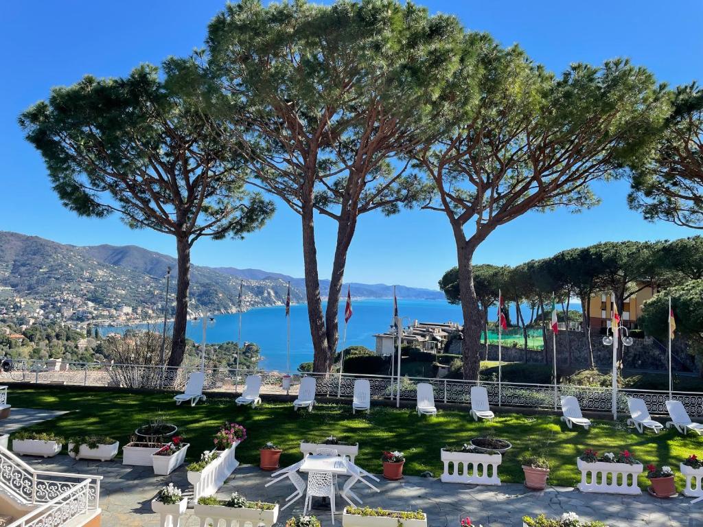 - une vue sur un parc avec des chaises et des arbres dans l'établissement Portofino Est Residence, à Rapallo