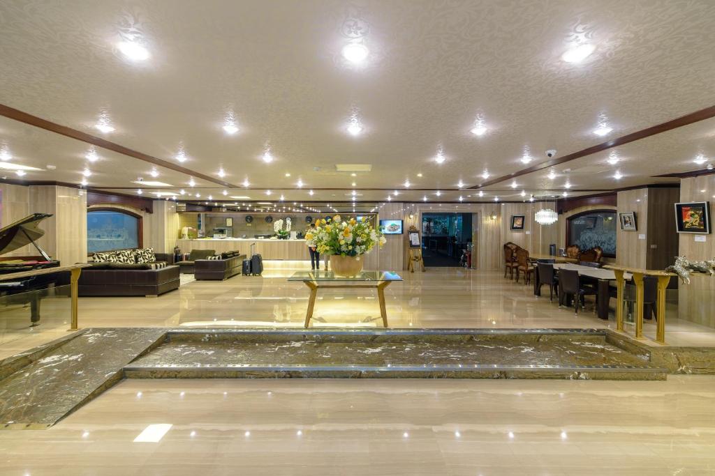 a large room with a lobby with a table with flowers at Chiayi King Hotel in Chiayi City