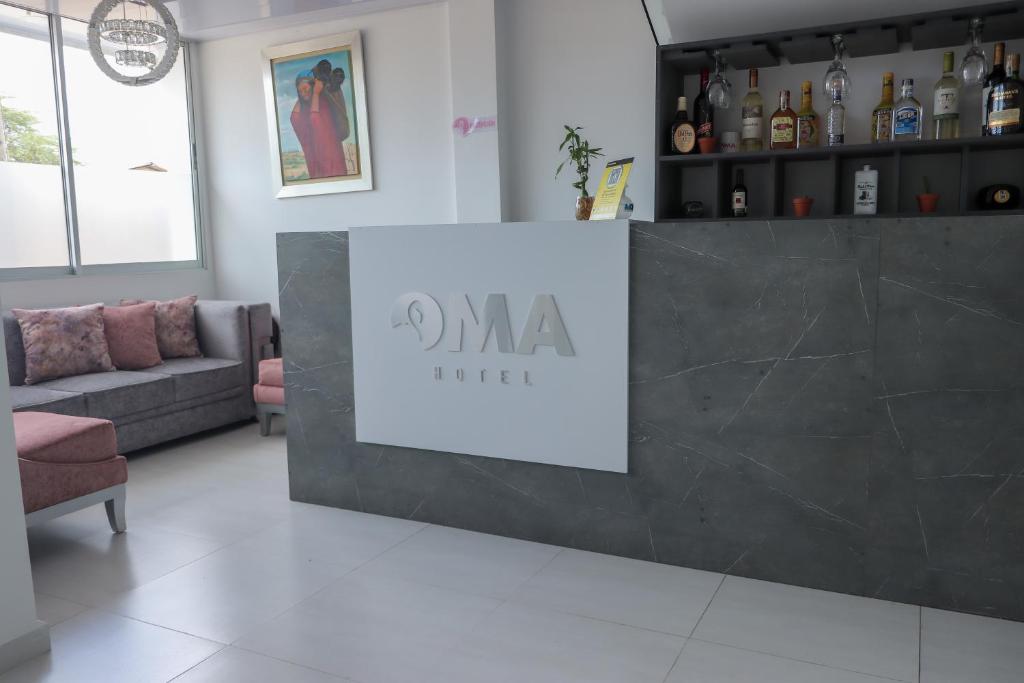 a lobby with a counter with a sign on it at OMA HOTEL LA GUAJIRA in Camarones