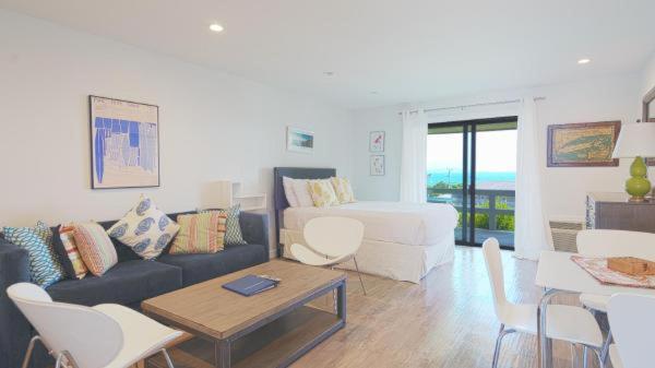 a living room with a couch and a table and chairs at Beachcomber Resort at Montauk in Montauk