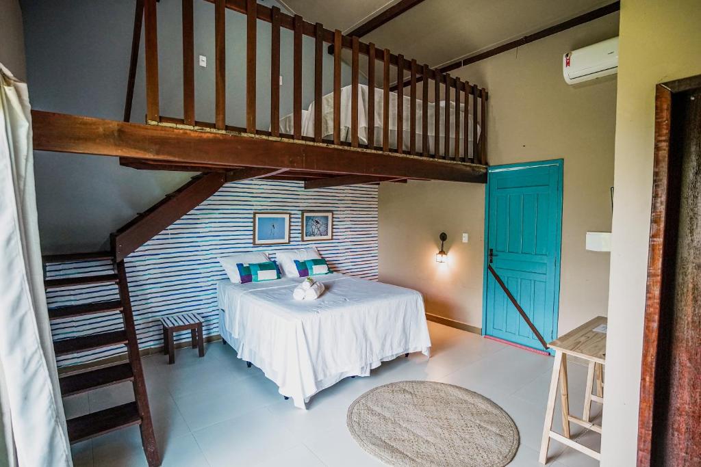 a bedroom with a bed with a ladder and a loft at Eco Resort Pedra Bonita in Santo Estêvão