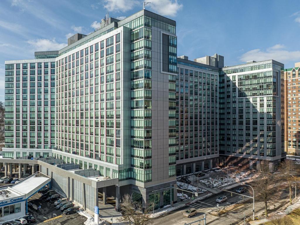 a tall building with many windows in a city at Global Luxury Suites Downtown White Plains in White Plains