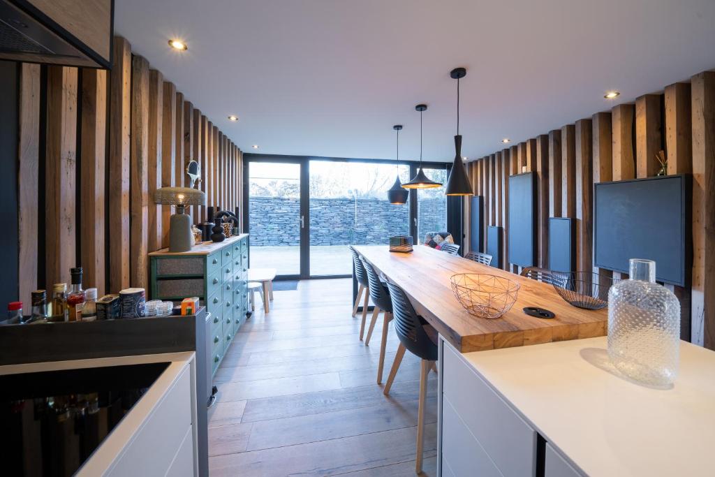 a kitchen with a counter with a wooden counter top at Gîtesdesignemoi entre Design et émotion - la perle in Onhaye