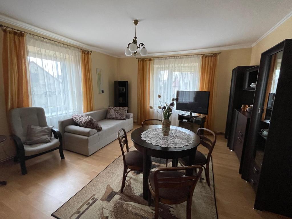 a living room with a table and a couch at Apartament in Bochnia