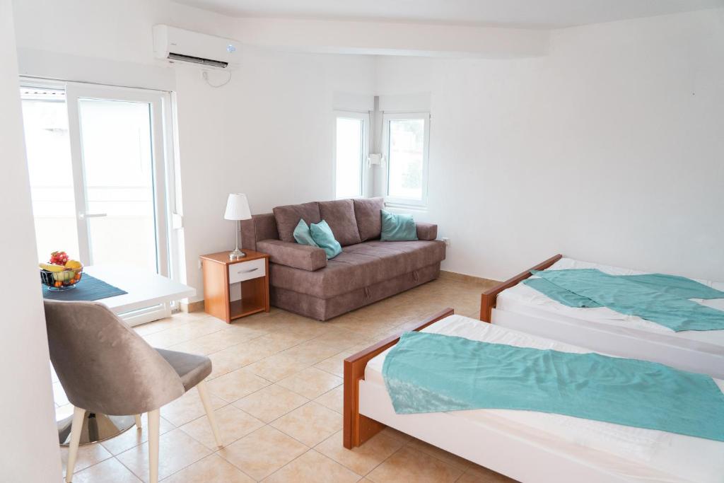 a living room with a bed and a couch at Apartments Sejla in Ulcinj