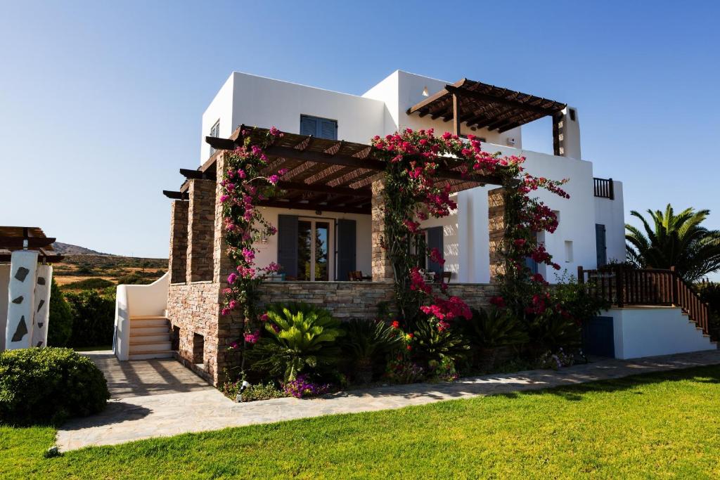 a villa with flowers on the front of it at Aeolos Villa in Lakhania