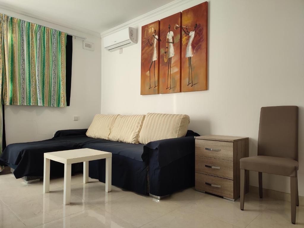 a living room with a couch and a table at One Bed Room Apartment with terrace in Marsaskala